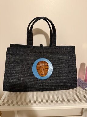 Black Handwoven Tote with Blue Medallion and Wooden Mask Accent